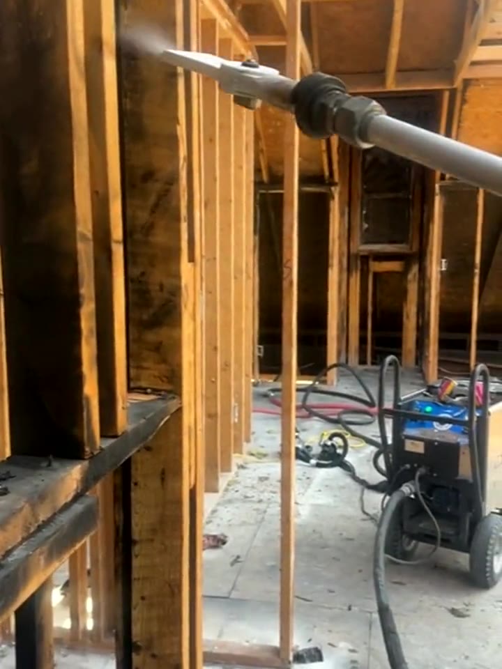 Interior wood framing after dry ice blasting with the Cold Jet unit in the background